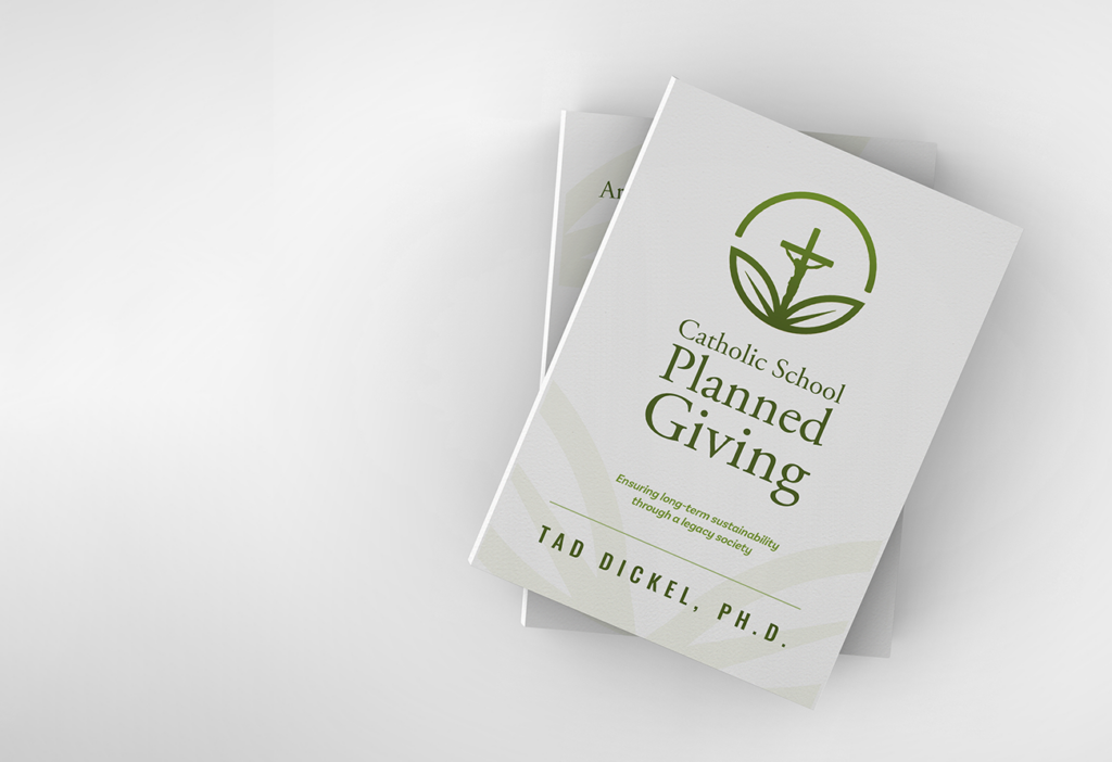 Isolated photo of a book titled "Catholic School Planned Giving" by Tad Dickel against a neutral background